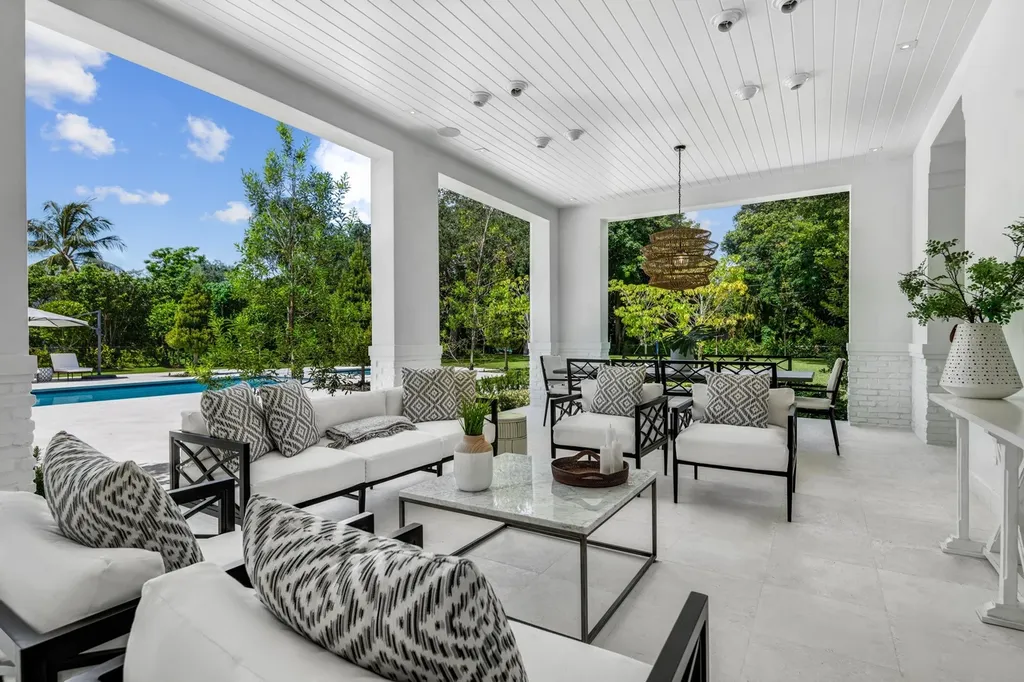 8840 SW 61st Court Home in Pinecrest, Florida. Explore this exquisite European-inspired home in N. Pinecrest, boasting 7 bedrooms and 7.5 bathrooms. From the formal living room with a wine cellar to the showstopper kitchen, this residence exudes elegance and sophistication.