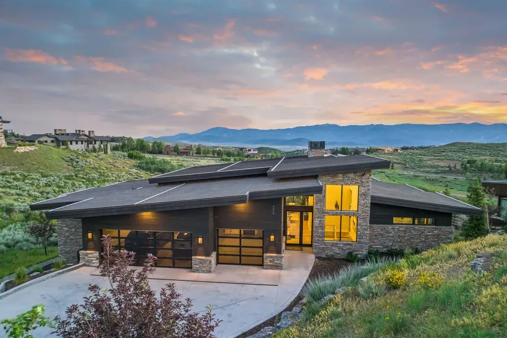 9310 Golden Spike Court Home in Park City, Utah. Discover this extraordinary custom home nestled on a 1.59-acre lot in Promontory's sought-after Summit neighborhood. Boasting stunning stone and cedar architecture under a striking copper roof, this home offers unobstructed ski area views and direct access to acres of open space. 