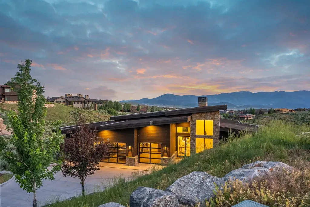 9310 Golden Spike Court Home in Park City, Utah. Discover this extraordinary custom home nestled on a 1.59-acre lot in Promontory's sought-after Summit neighborhood. Boasting stunning stone and cedar architecture under a striking copper roof, this home offers unobstructed ski area views and direct access to acres of open space. 