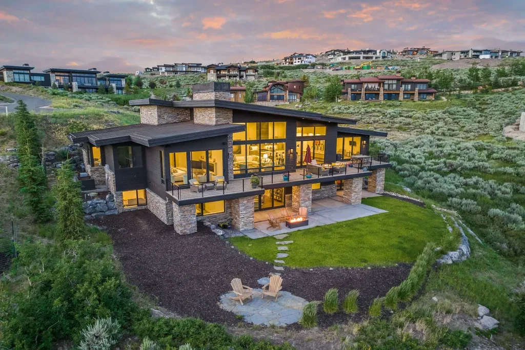 9310 Golden Spike Court Home in Park City, Utah. Discover this extraordinary custom home nestled on a 1.59-acre lot in Promontory's sought-after Summit neighborhood. Boasting stunning stone and cedar architecture under a striking copper roof, this home offers unobstructed ski area views and direct access to acres of open space. 