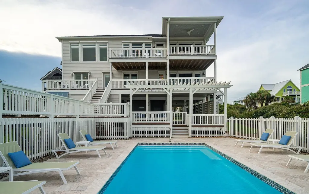 9721 Dolphin Ridge Road Home in Emerald Isle, North Carolina. Discover the epitome of oceanfront living in this exquisite Dolphin Ridge home, where luxury and customization intertwine to create a one-of-a-kind island sanctuary. Immerse yourself in the coastal lifestyle as you step into this beautifully furnished abode, thoughtfully tailored by the builder/owners to offer a seamless blend of comfort and sophistication.