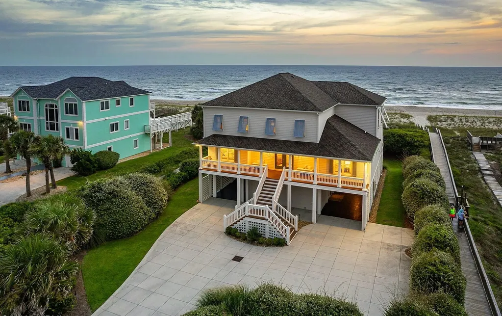 9721 Dolphin Ridge Road Home in Emerald Isle, North Carolina. Discover the epitome of oceanfront living in this exquisite Dolphin Ridge home, where luxury and customization intertwine to create a one-of-a-kind island sanctuary. Immerse yourself in the coastal lifestyle as you step into this beautifully furnished abode, thoughtfully tailored by the builder/owners to offer a seamless blend of comfort and sophistication.