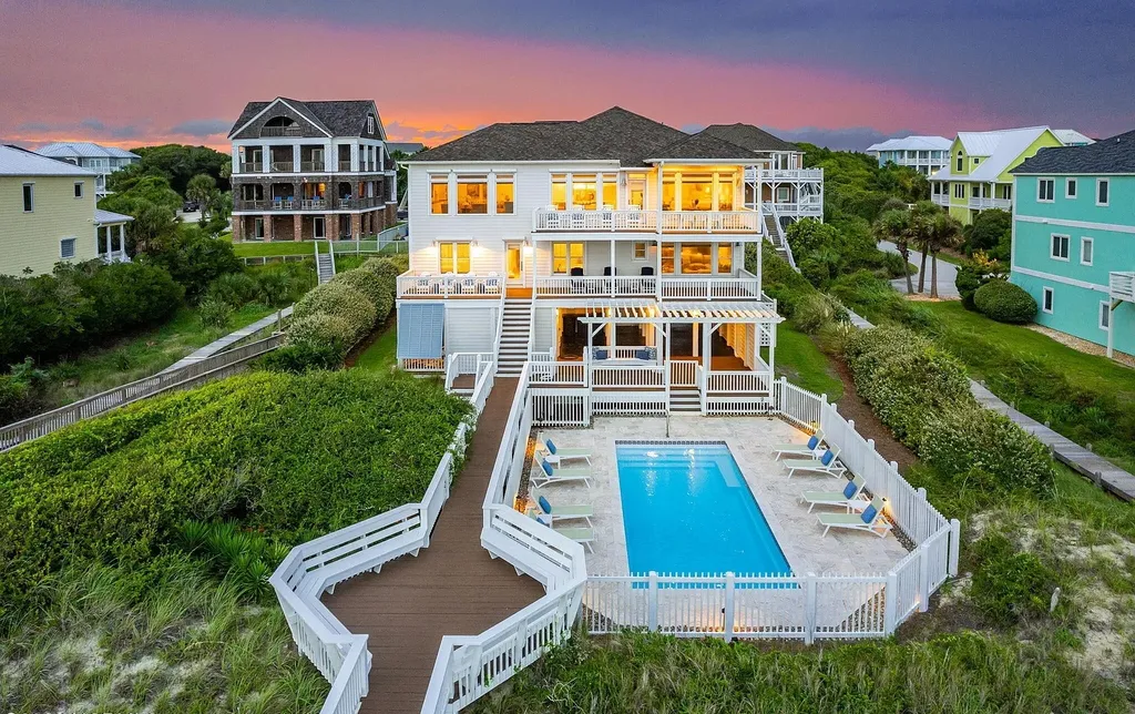 9721 Dolphin Ridge Road Home in Emerald Isle, North Carolina. Discover the epitome of oceanfront living in this exquisite Dolphin Ridge home, where luxury and customization intertwine to create a one-of-a-kind island sanctuary. Immerse yourself in the coastal lifestyle as you step into this beautifully furnished abode, thoughtfully tailored by the builder/owners to offer a seamless blend of comfort and sophistication.