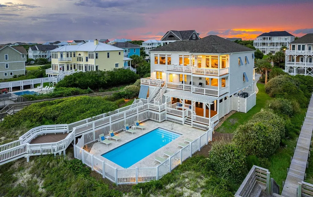 9721 Dolphin Ridge Road Home in Emerald Isle, North Carolina. Discover the epitome of oceanfront living in this exquisite Dolphin Ridge home, where luxury and customization intertwine to create a one-of-a-kind island sanctuary. Immerse yourself in the coastal lifestyle as you step into this beautifully furnished abode, thoughtfully tailored by the builder/owners to offer a seamless blend of comfort and sophistication.