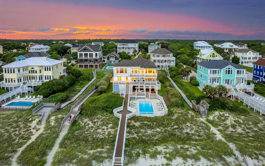9721 Dolphin Ridge Road Home in Emerald Isle, North Carolina. Discover the epitome of oceanfront living in this exquisite Dolphin Ridge home, where luxury and customization intertwine to create a one-of-a-kind island sanctuary. Immerse yourself in the coastal lifestyle as you step into this beautifully furnished abode, thoughtfully tailored by the builder/owners to offer a seamless blend of comfort and sophistication.