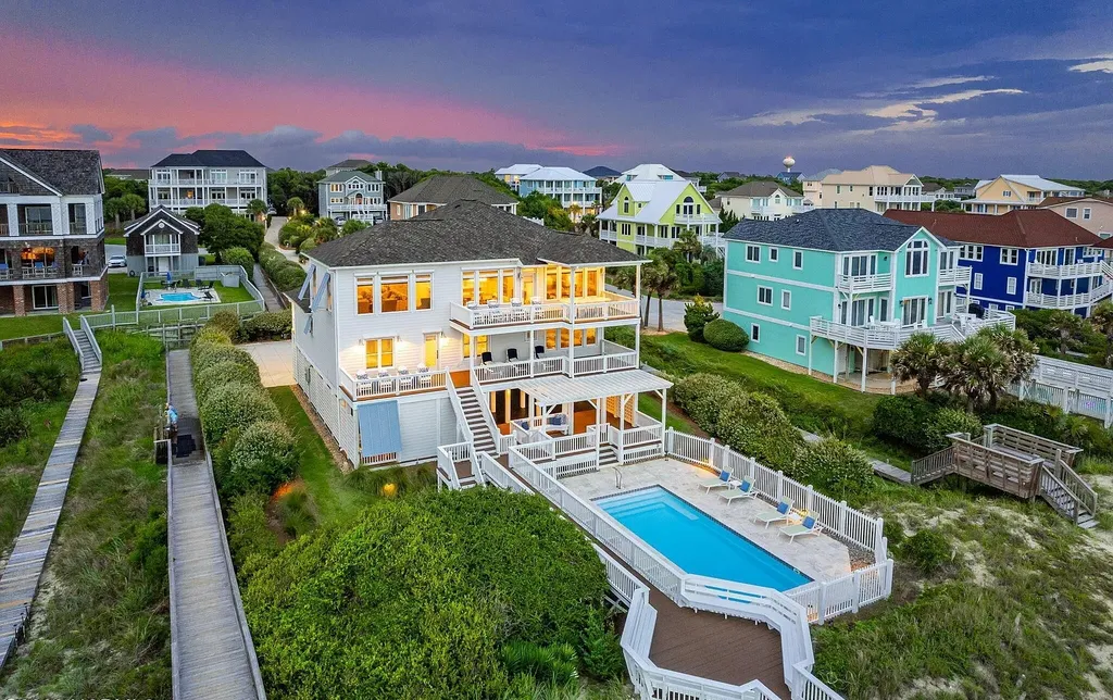 9721 Dolphin Ridge Road Home in Emerald Isle, North Carolina. Discover the epitome of oceanfront living in this exquisite Dolphin Ridge home, where luxury and customization intertwine to create a one-of-a-kind island sanctuary. Immerse yourself in the coastal lifestyle as you step into this beautifully furnished abode, thoughtfully tailored by the builder/owners to offer a seamless blend of comfort and sophistication.