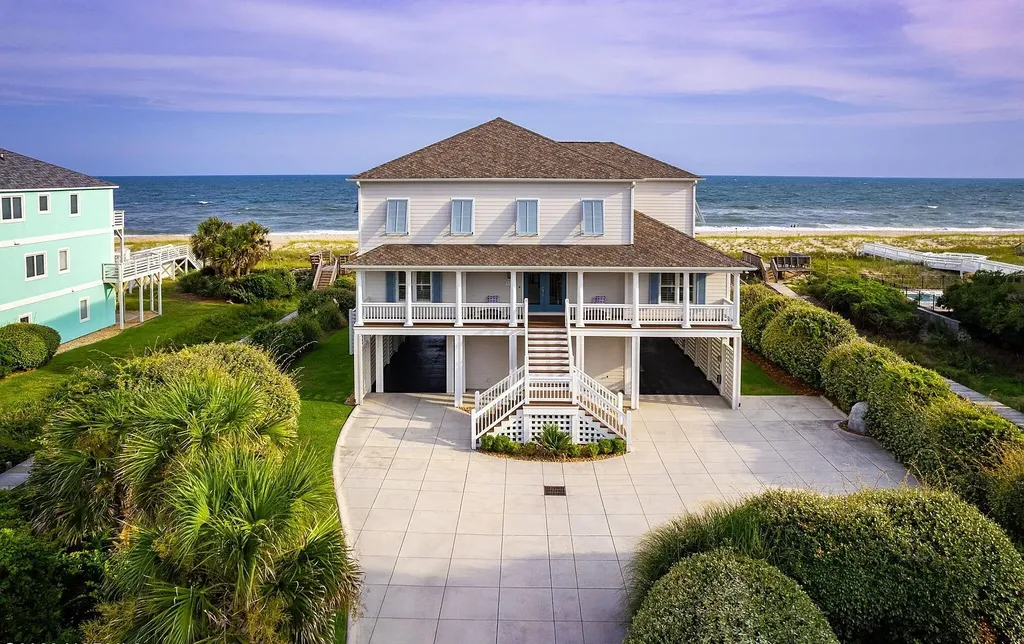 9721 Dolphin Ridge Road Home in Emerald Isle, North Carolina. Discover the epitome of oceanfront living in this exquisite Dolphin Ridge home, where luxury and customization intertwine to create a one-of-a-kind island sanctuary. Immerse yourself in the coastal lifestyle as you step into this beautifully furnished abode, thoughtfully tailored by the builder/owners to offer a seamless blend of comfort and sophistication.