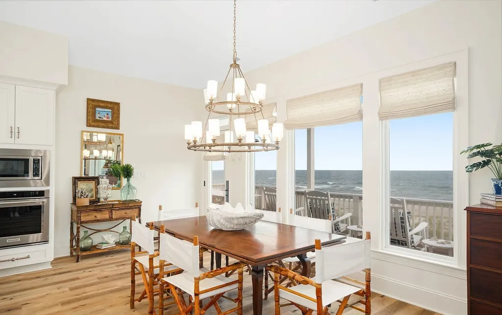 9721 Dolphin Ridge Road Home in Emerald Isle, North Carolina. Discover the epitome of oceanfront living in this exquisite Dolphin Ridge home, where luxury and customization intertwine to create a one-of-a-kind island sanctuary. Immerse yourself in the coastal lifestyle as you step into this beautifully furnished abode, thoughtfully tailored by the builder/owners to offer a seamless blend of comfort and sophistication.
