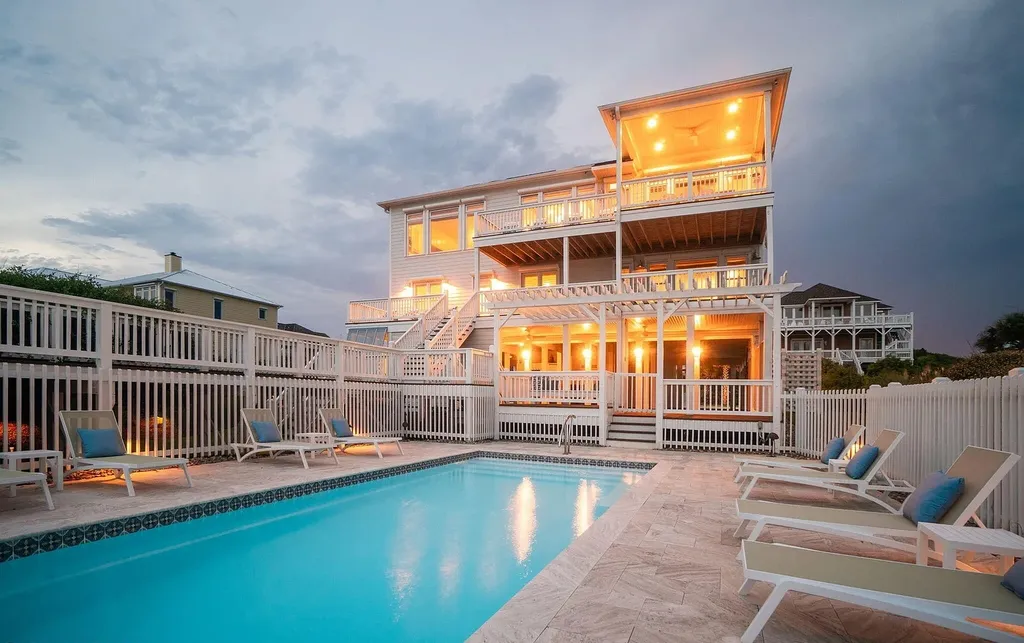 9721 Dolphin Ridge Road Home in Emerald Isle, North Carolina. Discover the epitome of oceanfront living in this exquisite Dolphin Ridge home, where luxury and customization intertwine to create a one-of-a-kind island sanctuary. Immerse yourself in the coastal lifestyle as you step into this beautifully furnished abode, thoughtfully tailored by the builder/owners to offer a seamless blend of comfort and sophistication.