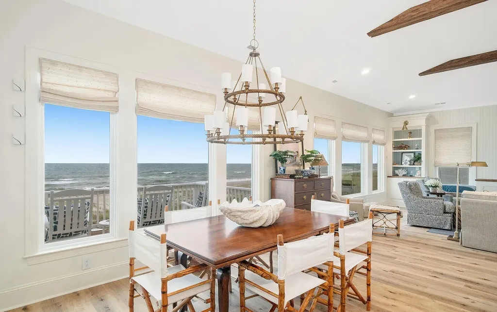 9721 Dolphin Ridge Road Home in Emerald Isle, North Carolina. Discover the epitome of oceanfront living in this exquisite Dolphin Ridge home, where luxury and customization intertwine to create a one-of-a-kind island sanctuary. Immerse yourself in the coastal lifestyle as you step into this beautifully furnished abode, thoughtfully tailored by the builder/owners to offer a seamless blend of comfort and sophistication.