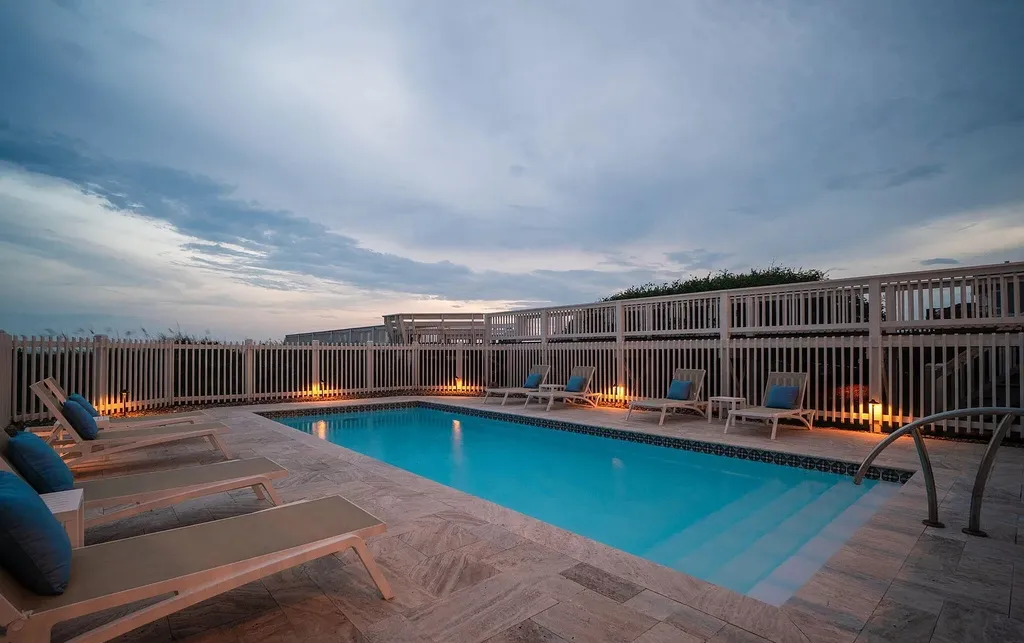 9721 Dolphin Ridge Road Home in Emerald Isle, North Carolina. Discover the epitome of oceanfront living in this exquisite Dolphin Ridge home, where luxury and customization intertwine to create a one-of-a-kind island sanctuary. Immerse yourself in the coastal lifestyle as you step into this beautifully furnished abode, thoughtfully tailored by the builder/owners to offer a seamless blend of comfort and sophistication.