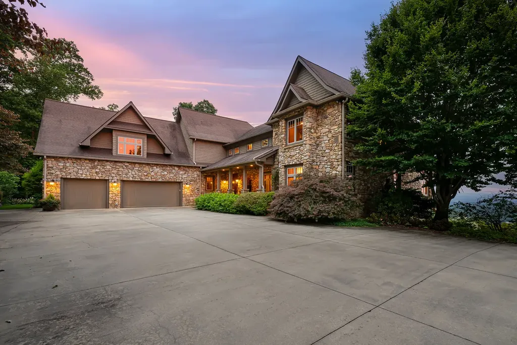 99 Crestridge Drive Home in Asheville, North Carolina. Discover a private haven in the exclusive Poplar Ridge community. Set at 3,000 ft elevation on 3+ acres, this home offers unmatched tranquility and stunning panoramic views. With main level living, gourmet kitchen, outdoor decks, and entertainment options like a media room and hot tub, this residence defines relaxation and comfort.