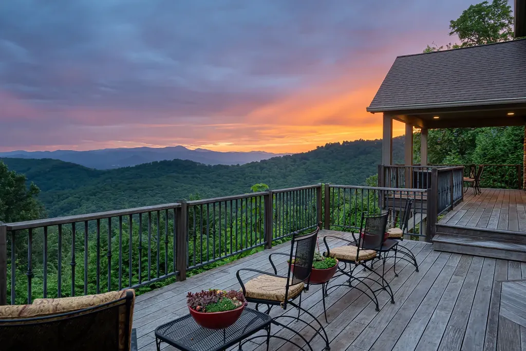 99 Crestridge Drive Home in Asheville, North Carolina. Discover a private haven in the exclusive Poplar Ridge community. Set at 3,000 ft elevation on 3+ acres, this home offers unmatched tranquility and stunning panoramic views. With main level living, gourmet kitchen, outdoor decks, and entertainment options like a media room and hot tub, this residence defines relaxation and comfort.