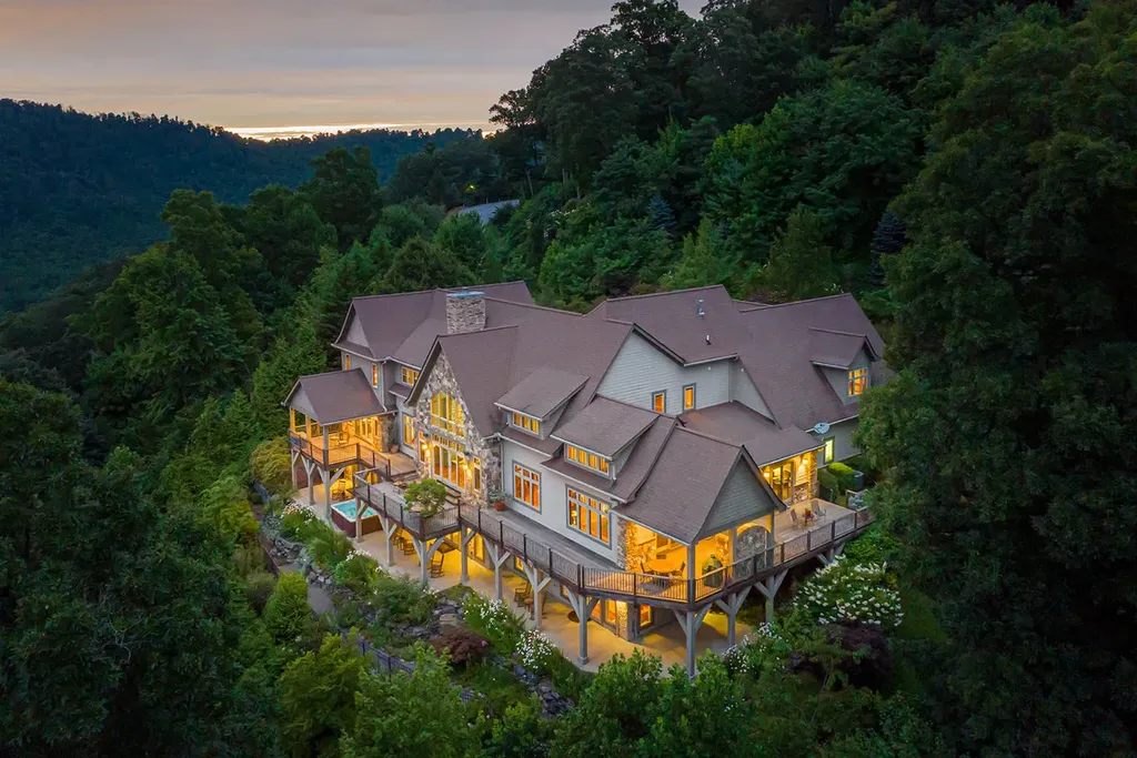 99 Crestridge Drive Home in Asheville, North Carolina. Discover a private haven in the exclusive Poplar Ridge community. Set at 3,000 ft elevation on 3+ acres, this home offers unmatched tranquility and stunning panoramic views. With main level living, gourmet kitchen, outdoor decks, and entertainment options like a media room and hot tub, this residence defines relaxation and comfort.