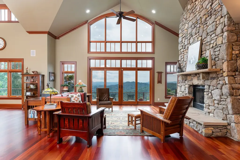 99 Crestridge Drive Home in Asheville, North Carolina. Discover a private haven in the exclusive Poplar Ridge community. Set at 3,000 ft elevation on 3+ acres, this home offers unmatched tranquility and stunning panoramic views. With main level living, gourmet kitchen, outdoor decks, and entertainment options like a media room and hot tub, this residence defines relaxation and comfort.
