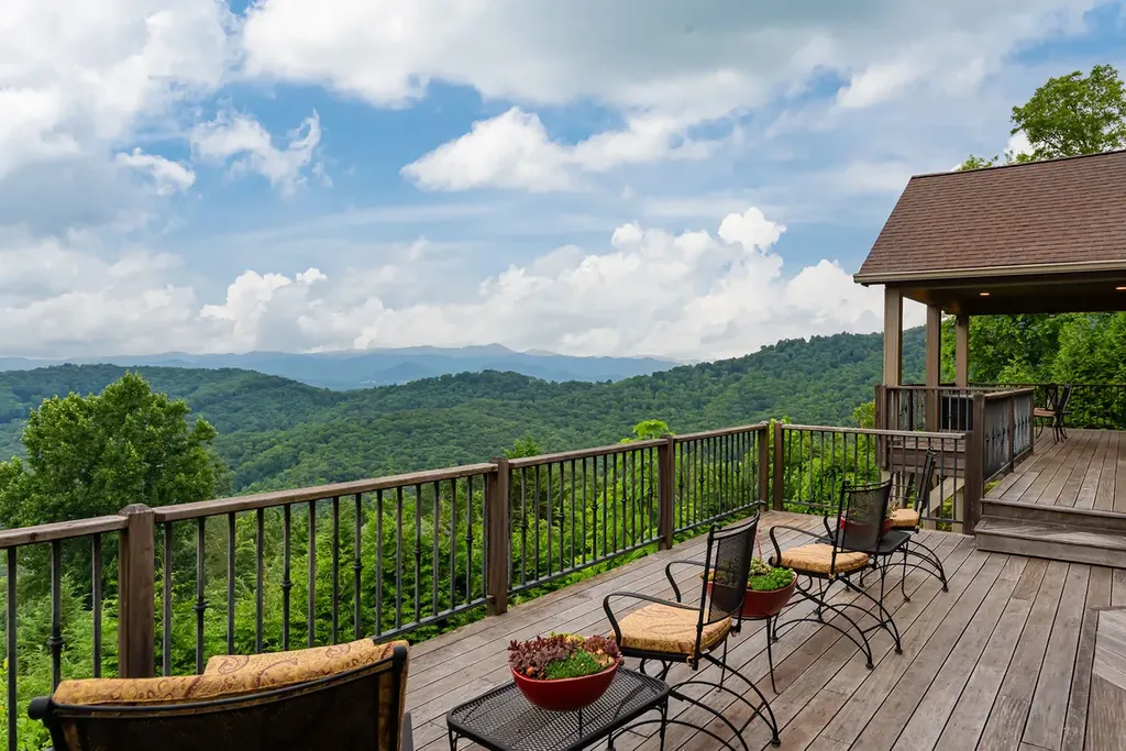 99 Crestridge Drive Home in Asheville, North Carolina. Discover a private haven in the exclusive Poplar Ridge community. Set at 3,000 ft elevation on 3+ acres, this home offers unmatched tranquility and stunning panoramic views. With main level living, gourmet kitchen, outdoor decks, and entertainment options like a media room and hot tub, this residence defines relaxation and comfort.