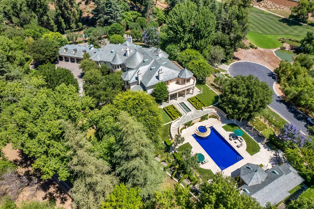 997 Brook Meadow Court Home in Westlake Village, California. Experience the epitome of luxury in this French country masterpiece located in the prestigious North Ranch Country Club Estates. Designed by renowned architect Ron Firestone, this iconic estate features a grand entry, theater, elevator, formal dining, bonus room, wine cellar, and a stunning primary suite. 