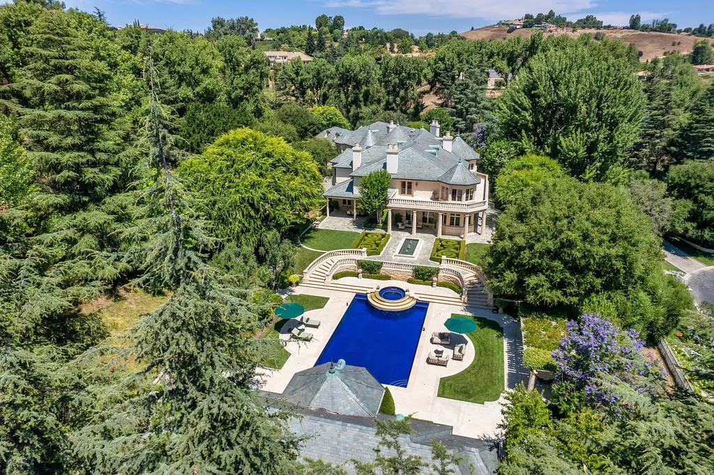 997 Brook Meadow Court Home in Westlake Village, California. Experience the epitome of luxury in this French country masterpiece located in the prestigious North Ranch Country Club Estates. Designed by renowned architect Ron Firestone, this iconic estate features a grand entry, theater, elevator, formal dining, bonus room, wine cellar, and a stunning primary suite. 