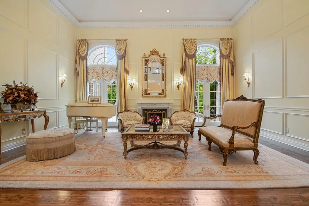 1 Lockhern Drive Home in Livingston Township, New Jersey. Step into the world of opulence with this custom-built, all-brick French Manor nestled on a tranquil cul-de-sac. The mature landscaping, saltwater pool, hot tub, limestone pool deck, and outdoor fireplace spanning 30 feet create a private oasis. Inside, discover a grand entrance hall leading to a stunning living room with a soaring 2-story ceiling, fireplace, and French doors opening to the patio and pool.