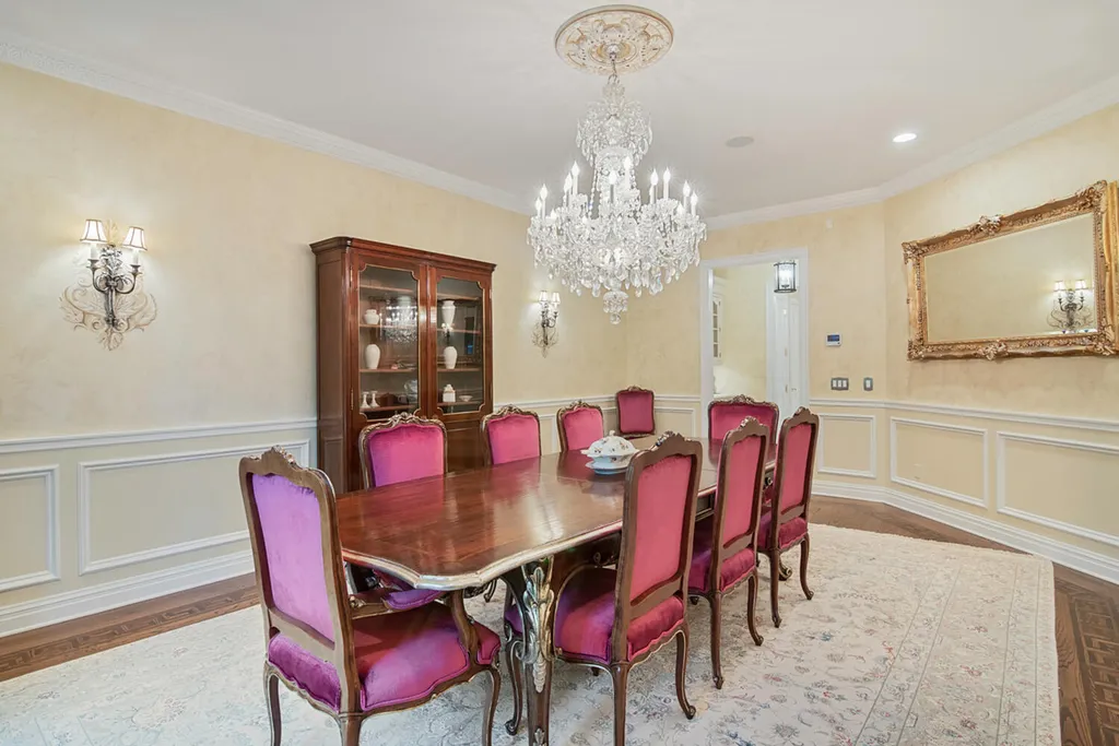 1 Lockhern Drive Home in Livingston Township, New Jersey. Step into the world of opulence with this custom-built, all-brick French Manor nestled on a tranquil cul-de-sac. The mature landscaping, saltwater pool, hot tub, limestone pool deck, and outdoor fireplace spanning 30 feet create a private oasis. Inside, discover a grand entrance hall leading to a stunning living room with a soaring 2-story ceiling, fireplace, and French doors opening to the patio and pool.