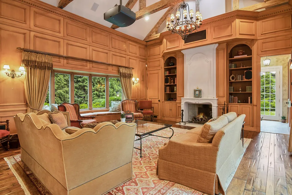 1 Lockhern Drive Home in Livingston Township, New Jersey. Step into the world of opulence with this custom-built, all-brick French Manor nestled on a tranquil cul-de-sac. The mature landscaping, saltwater pool, hot tub, limestone pool deck, and outdoor fireplace spanning 30 feet create a private oasis. Inside, discover a grand entrance hall leading to a stunning living room with a soaring 2-story ceiling, fireplace, and French doors opening to the patio and pool.