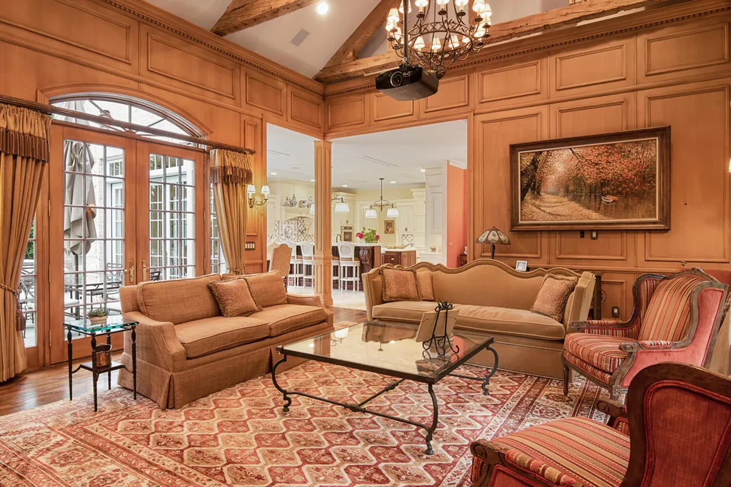 1 Lockhern Drive Home in Livingston Township, New Jersey. Step into the world of opulence with this custom-built, all-brick French Manor nestled on a tranquil cul-de-sac. The mature landscaping, saltwater pool, hot tub, limestone pool deck, and outdoor fireplace spanning 30 feet create a private oasis. Inside, discover a grand entrance hall leading to a stunning living room with a soaring 2-story ceiling, fireplace, and French doors opening to the patio and pool.
