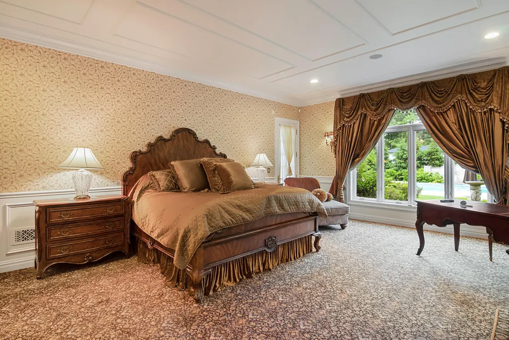 1 Lockhern Drive Home in Livingston Township, New Jersey. Step into the world of opulence with this custom-built, all-brick French Manor nestled on a tranquil cul-de-sac. The mature landscaping, saltwater pool, hot tub, limestone pool deck, and outdoor fireplace spanning 30 feet create a private oasis. Inside, discover a grand entrance hall leading to a stunning living room with a soaring 2-story ceiling, fireplace, and French doors opening to the patio and pool.
