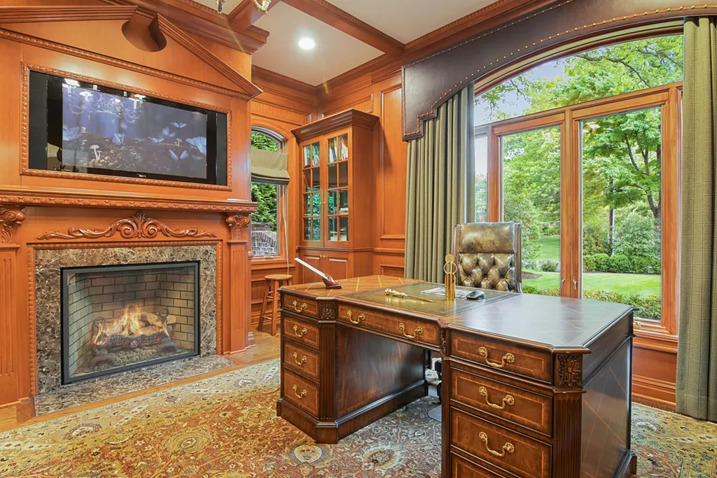 1 Lockhern Drive Home in Livingston Township, New Jersey. Step into the world of opulence with this custom-built, all-brick French Manor nestled on a tranquil cul-de-sac. The mature landscaping, saltwater pool, hot tub, limestone pool deck, and outdoor fireplace spanning 30 feet create a private oasis. Inside, discover a grand entrance hall leading to a stunning living room with a soaring 2-story ceiling, fireplace, and French doors opening to the patio and pool.