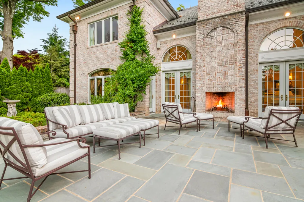 1 Lockhern Drive Home in Livingston Township, New Jersey. Step into the world of opulence with this custom-built, all-brick French Manor nestled on a tranquil cul-de-sac. The mature landscaping, saltwater pool, hot tub, limestone pool deck, and outdoor fireplace spanning 30 feet create a private oasis. Inside, discover a grand entrance hall leading to a stunning living room with a soaring 2-story ceiling, fireplace, and French doors opening to the patio and pool.