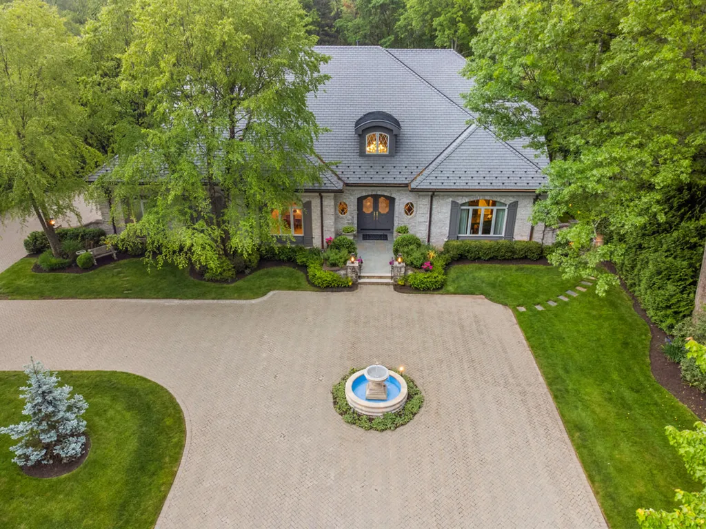 1 Lockhern Drive Home in Livingston Township, New Jersey. Step into the world of opulence with this custom-built, all-brick French Manor nestled on a tranquil cul-de-sac. The mature landscaping, saltwater pool, hot tub, limestone pool deck, and outdoor fireplace spanning 30 feet create a private oasis. Inside, discover a grand entrance hall leading to a stunning living room with a soaring 2-story ceiling, fireplace, and French doors opening to the patio and pool.