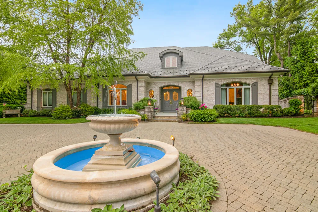 1 Lockhern Drive Home in Livingston Township, New Jersey. Step into the world of opulence with this custom-built, all-brick French Manor nestled on a tranquil cul-de-sac. The mature landscaping, saltwater pool, hot tub, limestone pool deck, and outdoor fireplace spanning 30 feet create a private oasis. Inside, discover a grand entrance hall leading to a stunning living room with a soaring 2-story ceiling, fireplace, and French doors opening to the patio and pool.