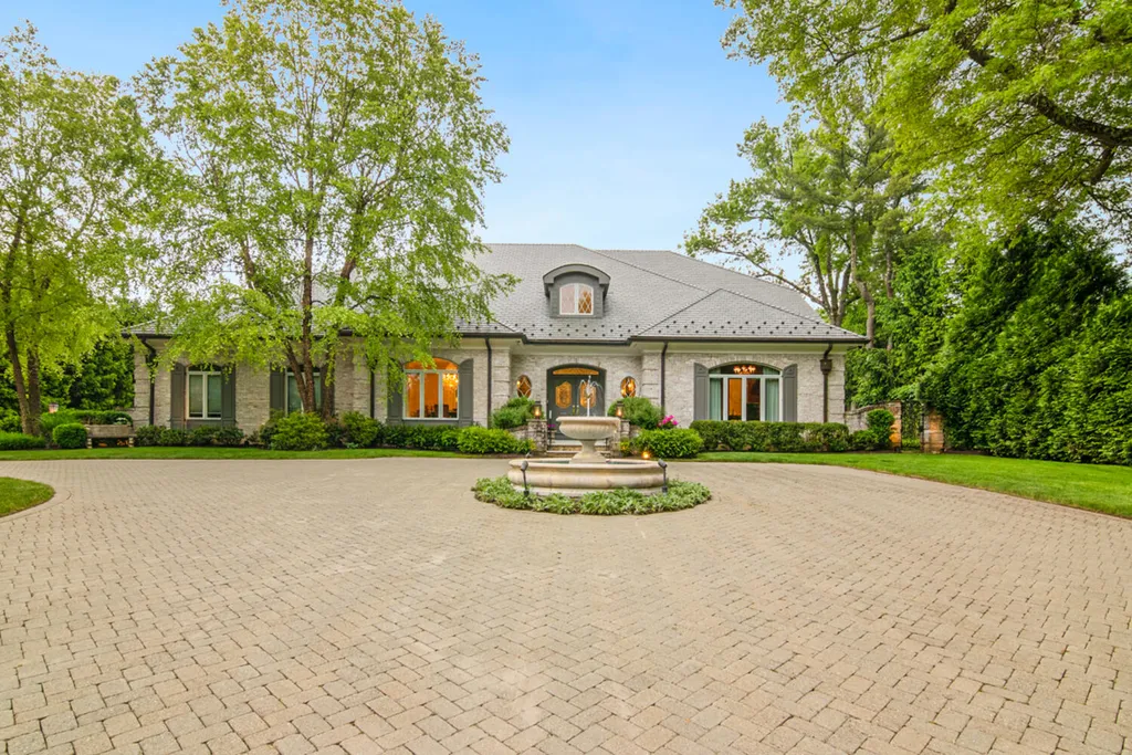 1 Lockhern Drive Home in Livingston Township, New Jersey. Step into the world of opulence with this custom-built, all-brick French Manor nestled on a tranquil cul-de-sac. The mature landscaping, saltwater pool, hot tub, limestone pool deck, and outdoor fireplace spanning 30 feet create a private oasis. Inside, discover a grand entrance hall leading to a stunning living room with a soaring 2-story ceiling, fireplace, and French doors opening to the patio and pool.