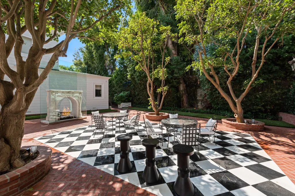 10250 West Sunset Boulevard Home in Los Angeles, California. Discover the epitome of luxury living at this meticulously reimagined Paul Williams designed estate in Holmby Hills, spanning approximately 2.8 acres. Comprising three structures with nearly 30,000 SF of living space, this world-class property offers unrivaled privacy, an expansive motor court, 14 bedrooms, 25 baths, and an array of amenities including a theater, game room, and a wellness-focused pool house. 