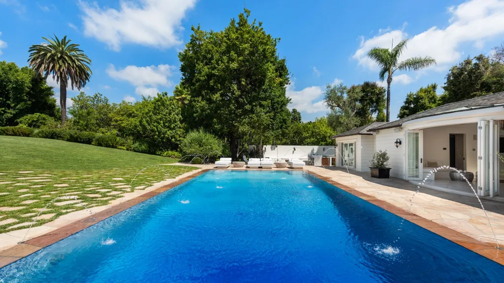 10250 West Sunset Boulevard Home in Los Angeles, California. Discover the epitome of luxury living at this meticulously reimagined Paul Williams designed estate in Holmby Hills, spanning approximately 2.8 acres. Comprising three structures with nearly 30,000 SF of living space, this world-class property offers unrivaled privacy, an expansive motor court, 14 bedrooms, 25 baths, and an array of amenities including a theater, game room, and a wellness-focused pool house. 