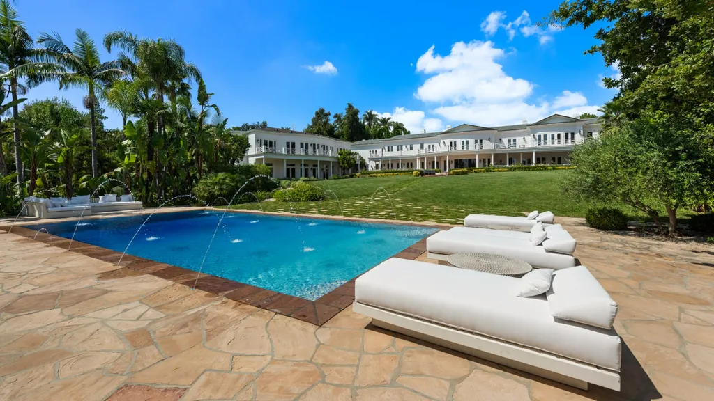 10250 West Sunset Boulevard Home in Los Angeles, California. Discover the epitome of luxury living at this meticulously reimagined Paul Williams designed estate in Holmby Hills, spanning approximately 2.8 acres. Comprising three structures with nearly 30,000 SF of living space, this world-class property offers unrivaled privacy, an expansive motor court, 14 bedrooms, 25 baths, and an array of amenities including a theater, game room, and a wellness-focused pool house. 