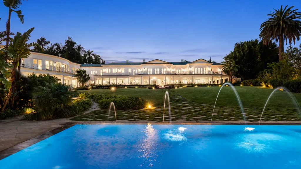 10250 West Sunset Boulevard Home in Los Angeles, California. Discover the epitome of luxury living at this meticulously reimagined Paul Williams designed estate in Holmby Hills, spanning approximately 2.8 acres. Comprising three structures with nearly 30,000 SF of living space, this world-class property offers unrivaled privacy, an expansive motor court, 14 bedrooms, 25 baths, and an array of amenities including a theater, game room, and a wellness-focused pool house. 