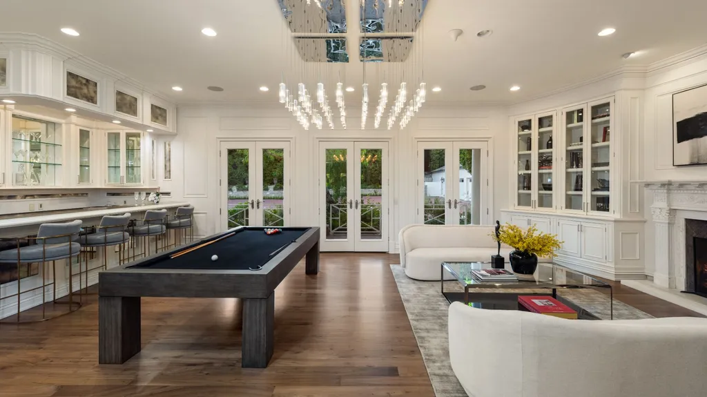 10250 West Sunset Boulevard Home in Los Angeles, California. Discover the epitome of luxury living at this meticulously reimagined Paul Williams designed estate in Holmby Hills, spanning approximately 2.8 acres. Comprising three structures with nearly 30,000 SF of living space, this world-class property offers unrivaled privacy, an expansive motor court, 14 bedrooms, 25 baths, and an array of amenities including a theater, game room, and a wellness-focused pool house. 