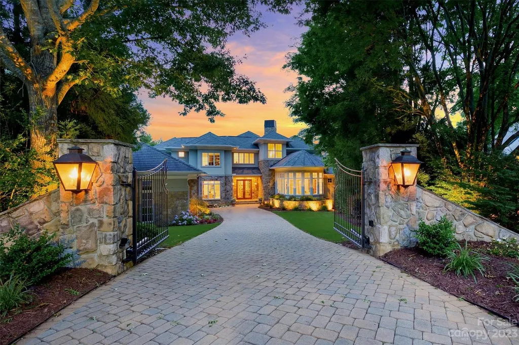 11717 Smart Lane Home in Charlotte, North Carolina. Experience the epitome of modern elegance in this gated estate with breathtaking views of the signature 13th hole from nearly every room and the stunning 48-ft pool. Designed by Christopher Phelps and crafted by Simonini, this home boasts an open floor plan, tall windows, curved walls, and a sweeping custom staircase inspired by Art Deco design.