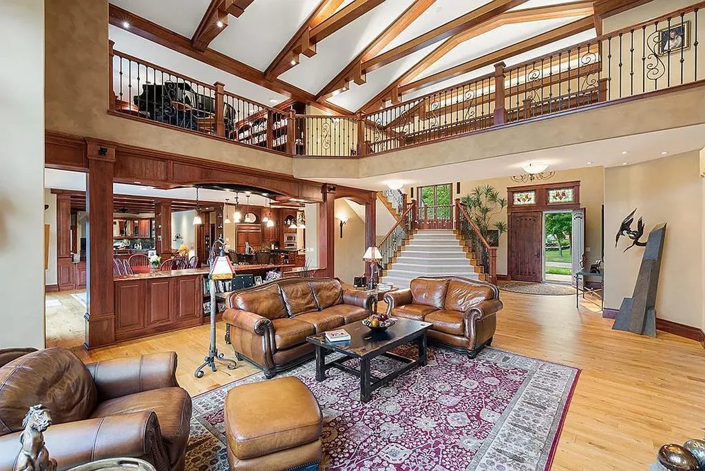 This stunning lakefront home is located in Cormorant Park Place, a premier lakeshore community. It has 6 bedrooms, 5 bathrooms, and 9,595 square feet of living space. The home features soaring ceilings, grand windows, hand-hewn imported wood, and hand-picked stone surfaces. It also has a private terrace with a fire pit, and access to the community's amenities, including a clubhouse, heated pool, swim beach, and slip system.