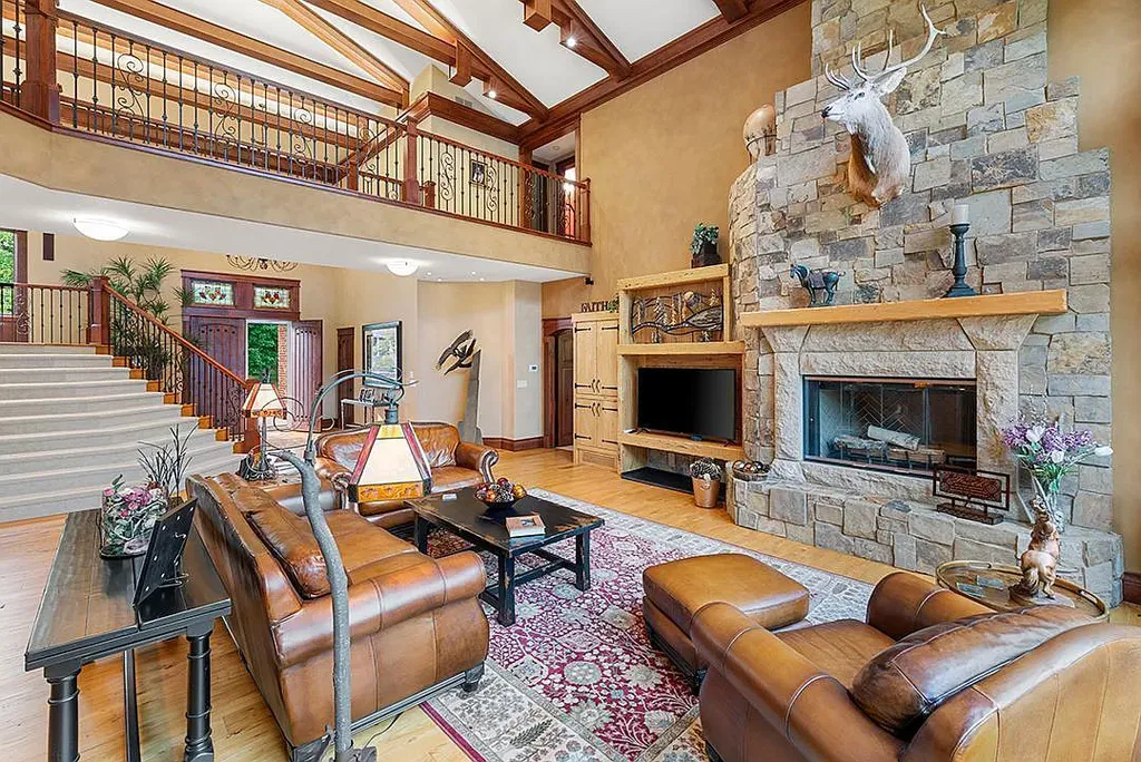 This stunning lakefront home is located in Cormorant Park Place, a premier lakeshore community. It has 6 bedrooms, 5 bathrooms, and 9,595 square feet of living space. The home features soaring ceilings, grand windows, hand-hewn imported wood, and hand-picked stone surfaces. It also has a private terrace with a fire pit, and access to the community's amenities, including a clubhouse, heated pool, swim beach, and slip system.