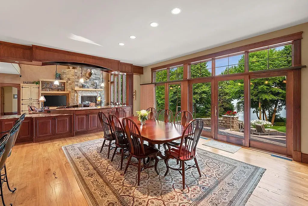 This stunning lakefront home is located in Cormorant Park Place, a premier lakeshore community. It has 6 bedrooms, 5 bathrooms, and 9,595 square feet of living space. The home features soaring ceilings, grand windows, hand-hewn imported wood, and hand-picked stone surfaces. It also has a private terrace with a fire pit, and access to the community's amenities, including a clubhouse, heated pool, swim beach, and slip system.