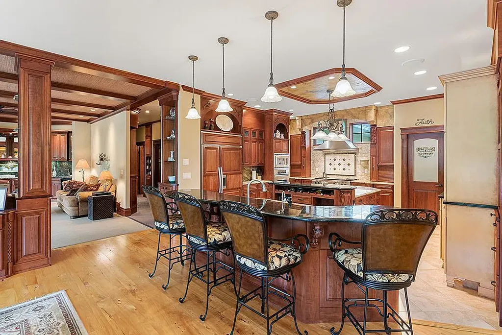 This stunning lakefront home is located in Cormorant Park Place, a premier lakeshore community. It has 6 bedrooms, 5 bathrooms, and 9,595 square feet of living space. The home features soaring ceilings, grand windows, hand-hewn imported wood, and hand-picked stone surfaces. It also has a private terrace with a fire pit, and access to the community's amenities, including a clubhouse, heated pool, swim beach, and slip system.