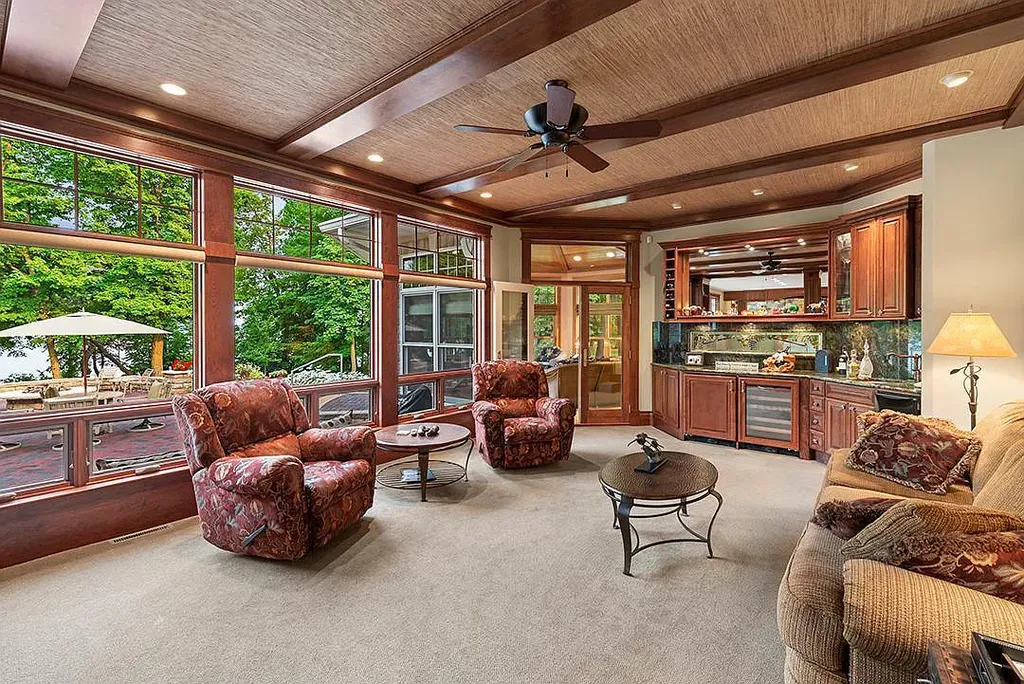 This stunning lakefront home is located in Cormorant Park Place, a premier lakeshore community. It has 6 bedrooms, 5 bathrooms, and 9,595 square feet of living space. The home features soaring ceilings, grand windows, hand-hewn imported wood, and hand-picked stone surfaces. It also has a private terrace with a fire pit, and access to the community's amenities, including a clubhouse, heated pool, swim beach, and slip system.