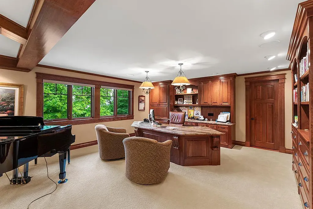 This stunning lakefront home is located in Cormorant Park Place, a premier lakeshore community. It has 6 bedrooms, 5 bathrooms, and 9,595 square feet of living space. The home features soaring ceilings, grand windows, hand-hewn imported wood, and hand-picked stone surfaces. It also has a private terrace with a fire pit, and access to the community's amenities, including a clubhouse, heated pool, swim beach, and slip system.