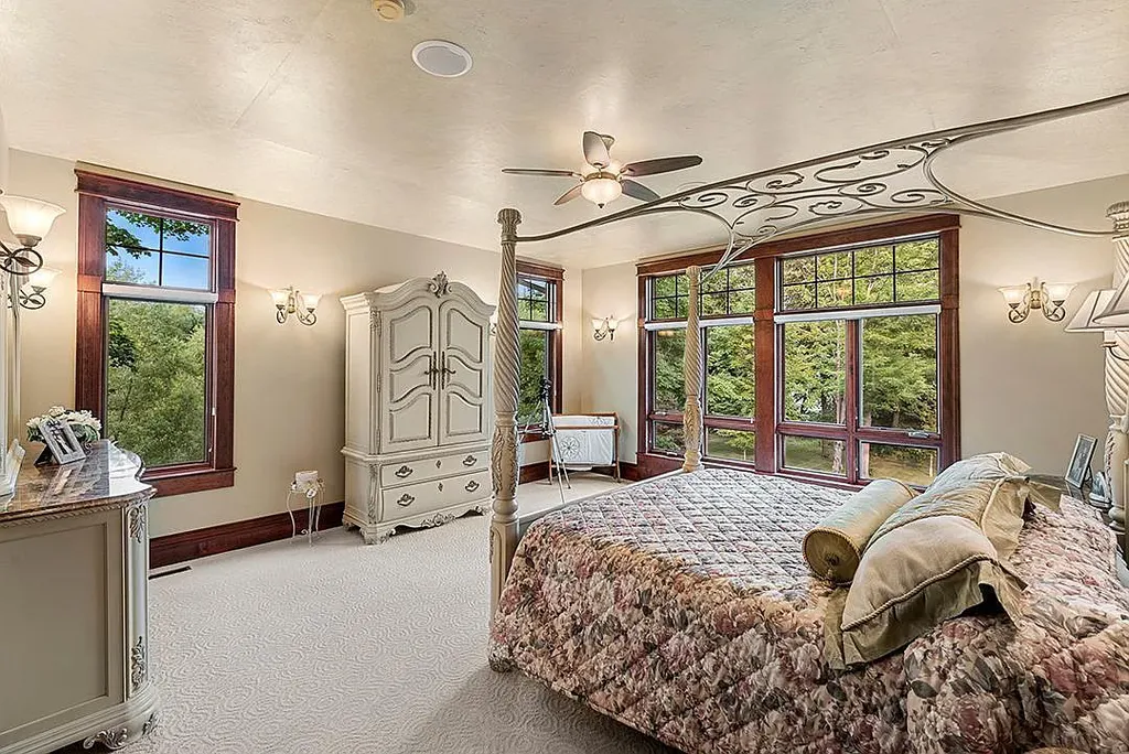 This stunning lakefront home is located in Cormorant Park Place, a premier lakeshore community. It has 6 bedrooms, 5 bathrooms, and 9,595 square feet of living space. The home features soaring ceilings, grand windows, hand-hewn imported wood, and hand-picked stone surfaces. It also has a private terrace with a fire pit, and access to the community's amenities, including a clubhouse, heated pool, swim beach, and slip system.