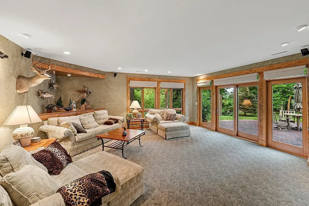 This stunning lakefront home is located in Cormorant Park Place, a premier lakeshore community. It has 6 bedrooms, 5 bathrooms, and 9,595 square feet of living space. The home features soaring ceilings, grand windows, hand-hewn imported wood, and hand-picked stone surfaces. It also has a private terrace with a fire pit, and access to the community's amenities, including a clubhouse, heated pool, swim beach, and slip system.