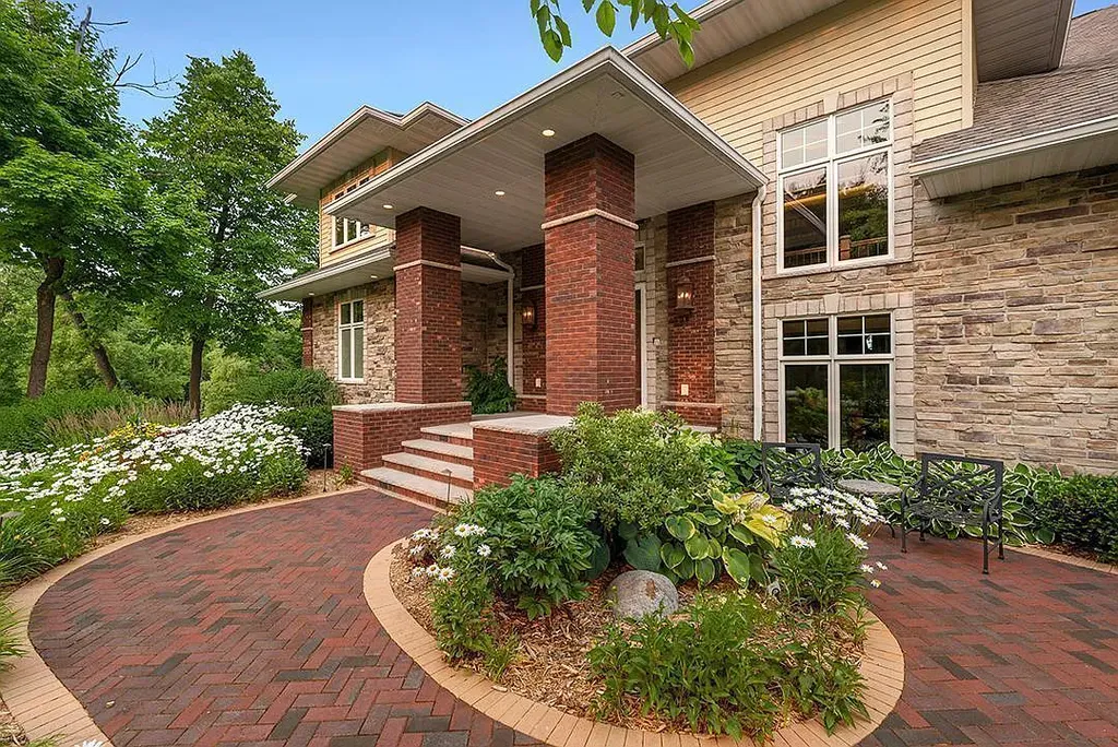This stunning lakefront home is located in Cormorant Park Place, a premier lakeshore community. It has 6 bedrooms, 5 bathrooms, and 9,595 square feet of living space. The home features soaring ceilings, grand windows, hand-hewn imported wood, and hand-picked stone surfaces. It also has a private terrace with a fire pit, and access to the community's amenities, including a clubhouse, heated pool, swim beach, and slip system.