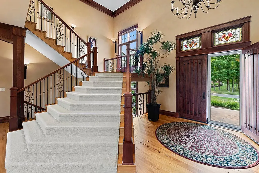 This stunning lakefront home is located in Cormorant Park Place, a premier lakeshore community. It has 6 bedrooms, 5 bathrooms, and 9,595 square feet of living space. The home features soaring ceilings, grand windows, hand-hewn imported wood, and hand-picked stone surfaces. It also has a private terrace with a fire pit, and access to the community's amenities, including a clubhouse, heated pool, swim beach, and slip system.