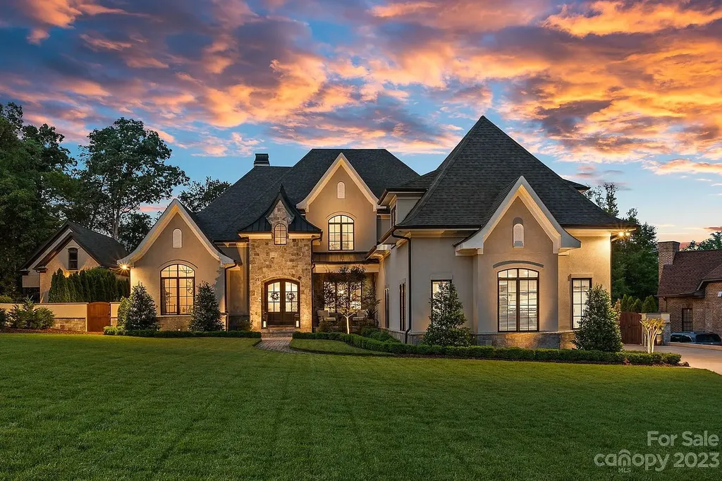 This stunning home in Providence Downs South offers luxury resort living with spa-like amenities, perfect for entertaining and relaxing. It has 5 bedrooms, 4 full baths, and 3 half baths, plus a 4-car garage with epoxy floor. The kitchen has a huge island with Wolf & Subzero appliances, and the backyard has a heated pool, hot tub, and pool house with sauna. 