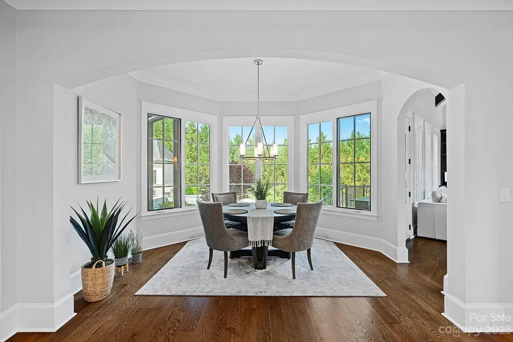 This stunning home in Providence Downs South offers luxury resort living with spa-like amenities, perfect for entertaining and relaxing. It has 5 bedrooms, 4 full baths, and 3 half baths, plus a 4-car garage with epoxy floor. The kitchen has a huge island with Wolf & Subzero appliances, and the backyard has a heated pool, hot tub, and pool house with sauna. 